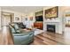 Cozy living room featuring a fireplace, hardwood flooring, and comfortable seating at 15788 Valentia St, Thornton, CO 80602