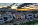 Exterior rear view of home showcasing lush landscaping, and a covered patio area, at sunset at 15788 Valentia St, Thornton, CO 80602