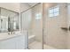 Contemporary bathroom featuring glass enclosed shower and a double vanity at 15788 Valentia St, Thornton, CO 80602