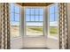 Large window with decorative valance offering expansive neighborhood views at 15788 Valentia St, Thornton, CO 80602