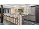 Basement bar area with bar stool seating, modern shelving and a television at 6915 Tremolite Dr, Castle Rock, CO 80108