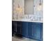 Bathroom featuring bright vanity with a modern faucet and a decorative tile backsplash at 6915 Tremolite Dr, Castle Rock, CO 80108