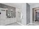 Bright bathroom featuring a modern vanity, a mirror, a glass shower, and decorative tiling at 6915 Tremolite Dr, Castle Rock, CO 80108