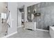 Modern bathroom featuring double vanity, stand alone tub, tiled accent wall, and glass shower at 6915 Tremolite Dr, Castle Rock, CO 80108