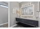 Modern bathroom featuring an illuminated mirror and unique tile accents at 6915 Tremolite Dr, Castle Rock, CO 80108