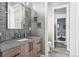 Stylish powder room featuring a wood vanity, unique mirror, and decorative accent wall at 6915 Tremolite Dr, Castle Rock, CO 80108