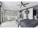 Bright bedroom featuring barn door access to a closet with a ceiling fan at 6915 Tremolite Dr, Castle Rock, CO 80108