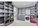 Large closet with custom shelving, drawers, and a dedicated laundry area at 6915 Tremolite Dr, Castle Rock, CO 80108