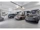 Spacious garage with epoxy floors, car lift, tool storage, and parking for 3 vehicles at 6915 Tremolite Dr, Castle Rock, CO 80108