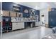 Well-lit garage with epoxy floors, workbench, tool storage, and stylish design at 6915 Tremolite Dr, Castle Rock, CO 80108