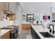 Modern kitchen with stainless steel appliances, large island, sleek countertops and designer tile backsplash at 6915 Tremolite Dr, Castle Rock, CO 80108