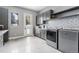 Well-organized laundry room equipped with modern appliances, storage cabinets, and eye catching backsplash at 6915 Tremolite Dr, Castle Rock, CO 80108