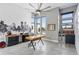 Bright home office space with modern lighting, large windows, and a sleek wet bar at 6915 Tremolite Dr, Castle Rock, CO 80108