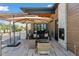 Outdoor patio with a fireplace, grill and stylish seating area at 6915 Tremolite Dr, Castle Rock, CO 80108