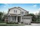Charming two-story home featuring a two-car garage, stone accents, and a beautifully landscaped front yard at 7377 S Yank Ct, Littleton, CO 80127