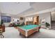 Finished basement with billiard table, bar, and seating area perfect for entertaining guests at 15976 Quarry Hill Dr, Parker, CO 80134