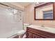 Bathroom featuring a glass-enclosed shower, wood vanity, and neutral walls at 15976 Quarry Hill Dr, Parker, CO 80134