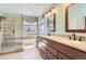 Well-appointed bathroom with a double vanity, tiled shower, and ample natural light for a spa-like experience at 15976 Quarry Hill Dr, Parker, CO 80134