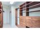 Spacious walk-in closet boasts custom wood shelving, drawers, and ample hanging space for organization at 15976 Quarry Hill Dr, Parker, CO 80134