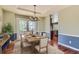 Inviting dining room with a wooden table set for a meal, bathed in natural light from the French doors at 15976 Quarry Hill Dr, Parker, CO 80134