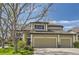 Beautiful home featuring a three-car garage, green lawn, and mature tree shading the property in the daytime at 15976 Quarry Hill Dr, Parker, CO 80134