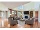 Comfortable living room with a fireplace, built-in shelves, and ample seating, perfect for relaxation and gatherings at 15976 Quarry Hill Dr, Parker, CO 80134