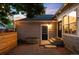 Backyard with a brick patio, planter box, string lights, and neutral siding, creating a charming outdoor space at 1947 King St, Denver, CO 80204