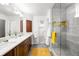 Bathroom features double sinks, wood cabinets, walk-in shower with mosaic tile, and a view into the bedroom at 1947 King St, Denver, CO 80204