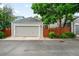 Detached one-car garage with gray siding, complemented by a privacy fence and landscaping at 1947 King St, Denver, CO 80204