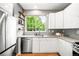 Bright, modern kitchen featuring stainless steel appliances and granite countertops at 1947 King St, Denver, CO 80204