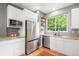 Bright kitchen with stainless steel appliances, white cabinets and an eat-in breakfast area, perfect for modern living at 1947 King St, Denver, CO 80204