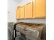 Well-organized laundry room with light wood cabinets and modern, front-loading washer and dryer at 1947 King St, Denver, CO 80204