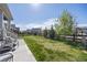 Landscaped backyard with a grass lawn, charming fence, and a cozy patio area at 806 Cabot Dr, Erie, CO 80516