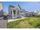 Backyard with a covered patio, green lawn, and gravel accents, creating a lovely outdoor space at 806 Cabot Dr, Erie, CO 80516