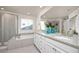 Luxurious bathroom features a soaking tub, glass-enclosed shower, double vanity, and granite countertops at 806 Cabot Dr, Erie, CO 80516