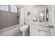 Modern bathroom features a shower with gray tiling and a sleek marble-top vanity at 806 Cabot Dr, Erie, CO 80516