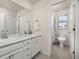 Bright bathroom with double sinks and a walk-in shower in an adjacent space at 806 Cabot Dr, Erie, CO 80516