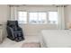 Sunny bedroom features large windows, neutral decor, and plush carpet at 806 Cabot Dr, Erie, CO 80516