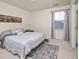 Neutral bedroom features a patterned rug and a comfortable bed with a city skyline picture at 806 Cabot Dr, Erie, CO 80516