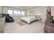 Bright, spacious bedroom features a massage chair, neutral decor, and a large window for natural light at 806 Cabot Dr, Erie, CO 80516