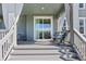 Covered patio with sliding door, comfortable seating, and stylish curtains for outdoor relaxation at 806 Cabot Dr, Erie, CO 80516