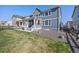 Charming exterior view featuring a covered porch, fenced yard, and manicured landscaping at 806 Cabot Dr, Erie, CO 80516