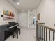 Upstairs hallway features neutral carpet, decorative wall art, and access to the bedrooms at 806 Cabot Dr, Erie, CO 80516