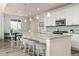 Open kitchen features a breakfast bar, pendant lighting, stainless appliances, and a view to the dining area at 806 Cabot Dr, Erie, CO 80516