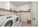 Organized laundry room with modern washer and dryer, plus ample storage at 806 Cabot Dr, Erie, CO 80516