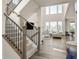 Open-concept living area with staircase and large windows at 806 Cabot Dr, Erie, CO 80516
