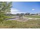 Community playground with swings and play areas, surrounded by lush greenery and neighborhood homes at 806 Cabot Dr, Erie, CO 80516
