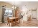 Kitchen and dining area with wood table and stainless steel appliances at 7684 Mule Deer Pl, Littleton, CO 80125