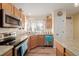 Cozy kitchen features stainless steel appliances and light wood cabinets at 7684 Mule Deer Pl, Littleton, CO 80125