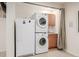 Convenient laundry room with washer, dryer, and extra fridge at 7684 Mule Deer Pl, Littleton, CO 80125